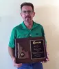 Tim Melody holding a Driver of the Year award