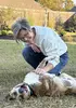 Carol Sikes and dog, Douglas, playing in the backyard 