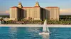 Exterior of the Ritz-Carlton Naples with a sailboat in the foreground.