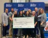 ArcBest employees donate a check to the Arvest Million Meals Campaign